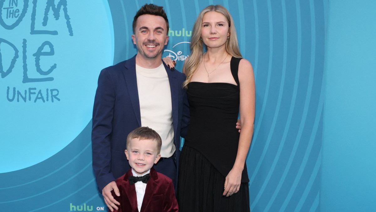 Frankie Muniz poses on the red carpet with his wife Paige Price and their son