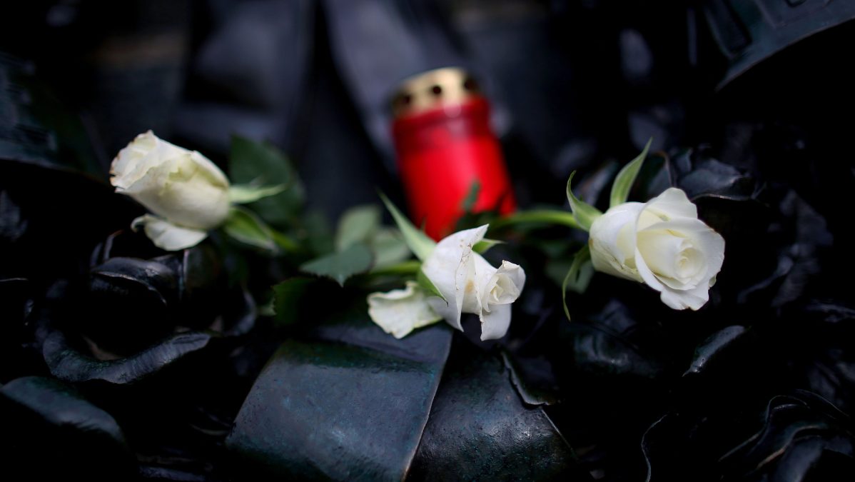 A candle and flowers for Rosalind Ashford.