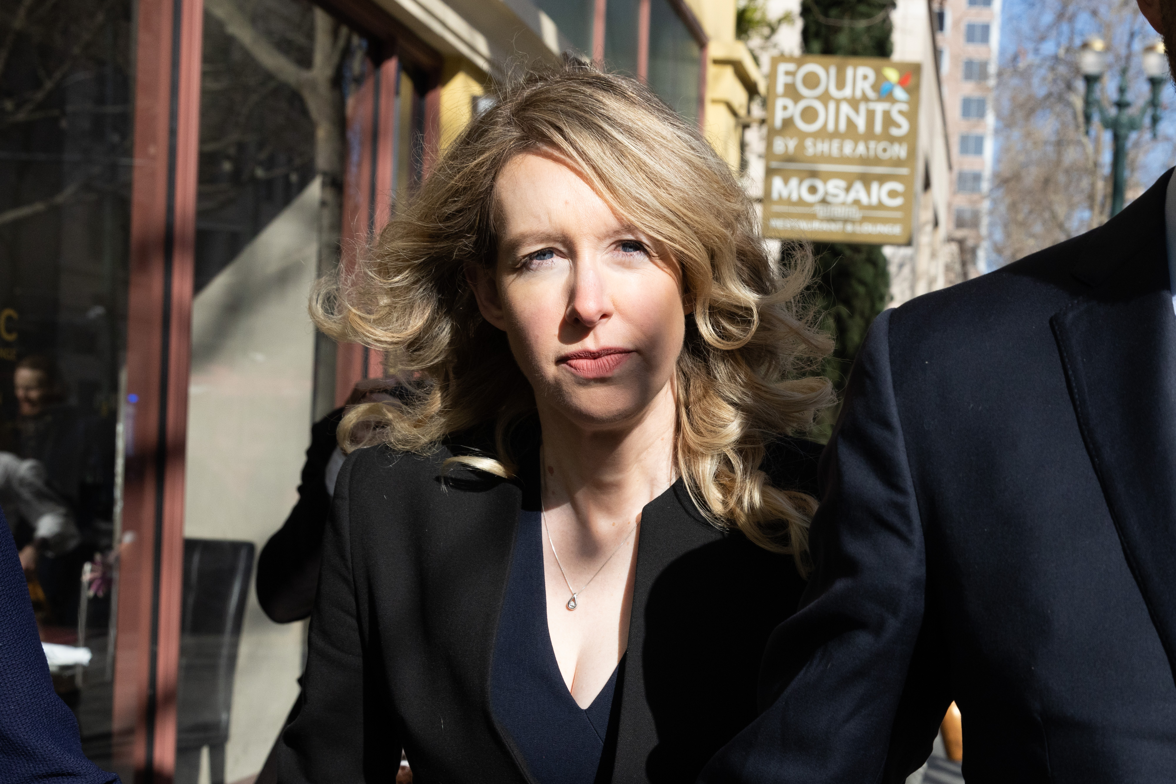 Elizabeth Holmes looks into camera before court