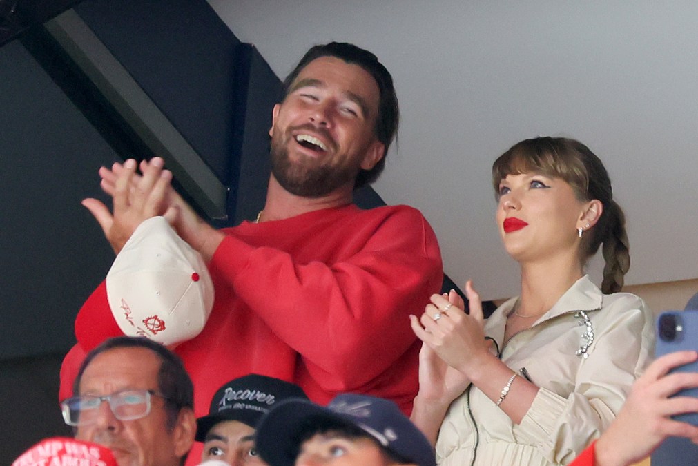 Travis Kelce and Taylor Swift clapping in the crowd at the 2025 Stanley Cup Final