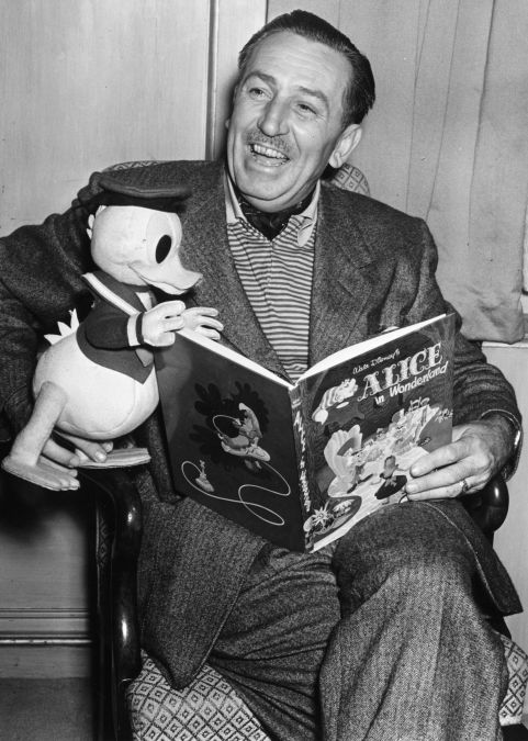 Walt Disney reading an "Alice in Wonderland" book