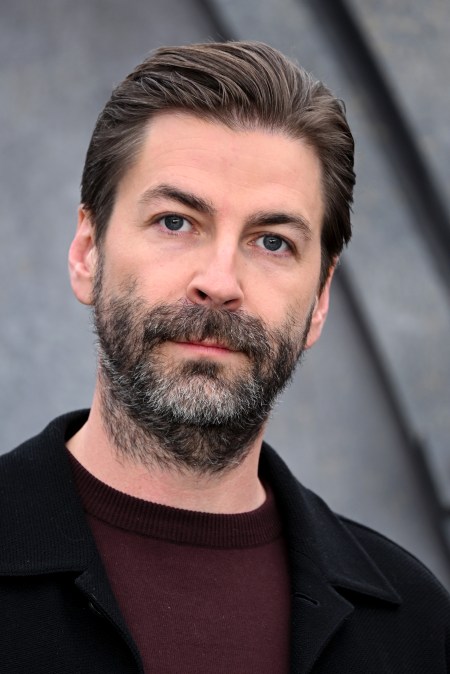 Jon Watts at an event in a black suit.