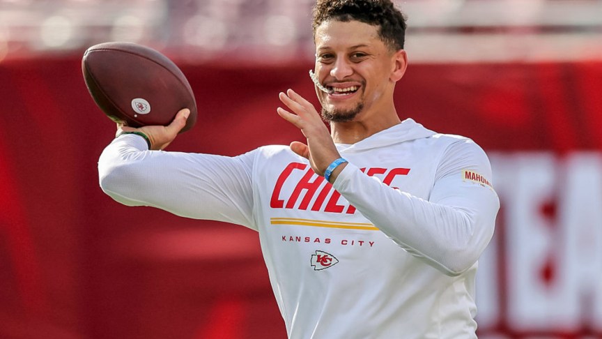 Patrick Mahomes smiling on the field