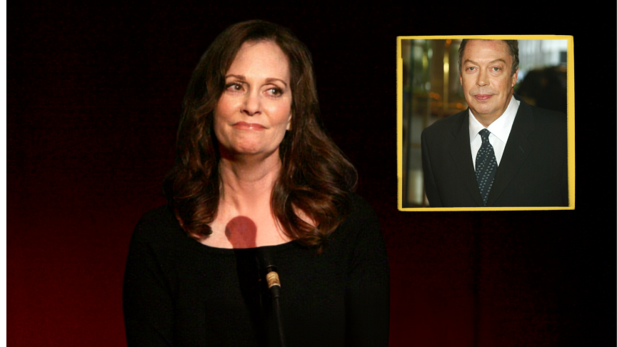 Lesley Ann Warren stands on stage in a black dress. She looks to left and there is a picture of Tim Curry.