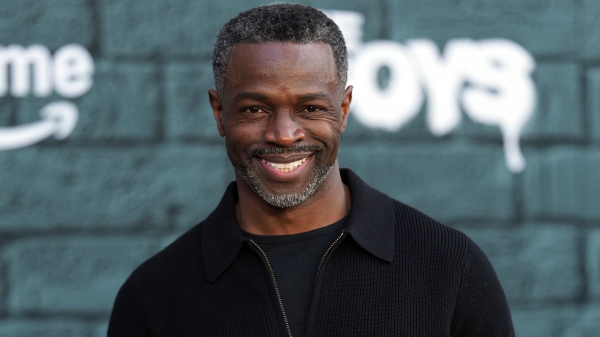 Sean Patrick Thomas smiles in black clothing.
