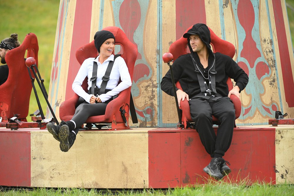Maura Higgins and Rob Rausch sit next to each other on a carnival ride.