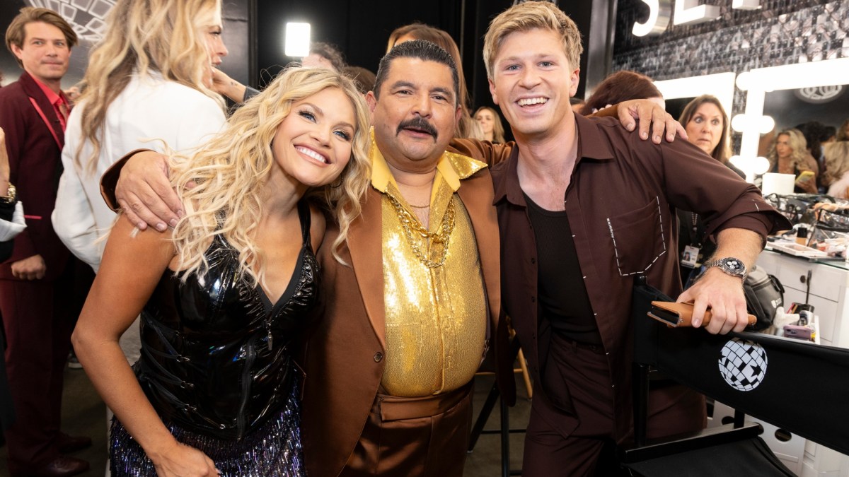 Witney Carson, Guillermo Rodriguez, and Robert Irwin huddle together at a Sephora station.