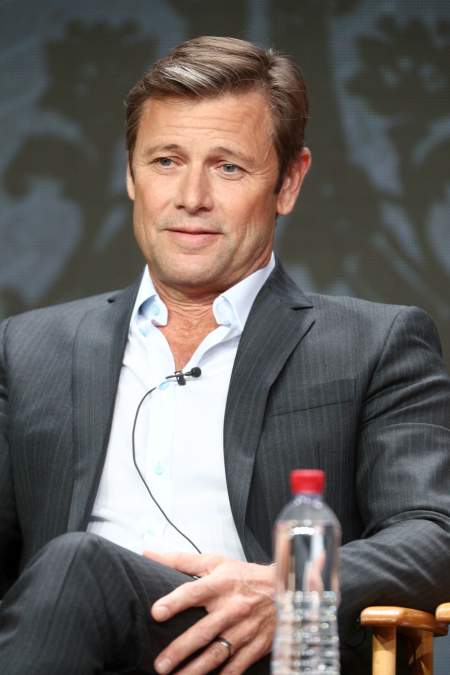 Grant Show speaking onstage at an event in 2017