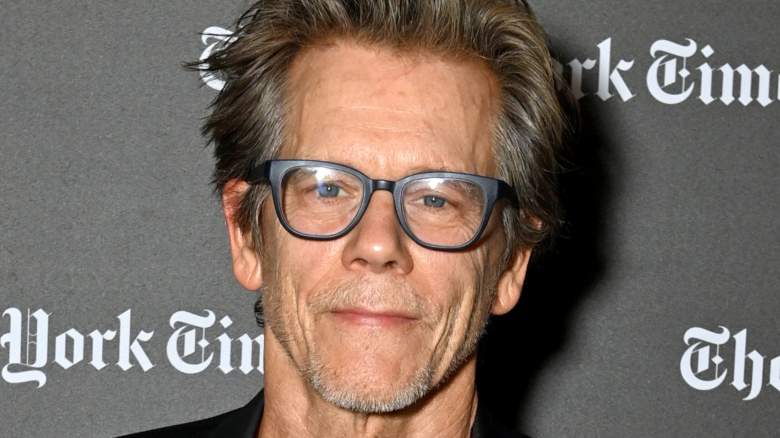 Kevin Bacon smiling and posing for photos at an event