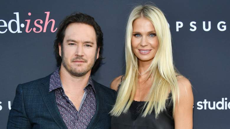 Mark-Paul Gosselaar stands next to Catriona McGinn on a step and repeat.